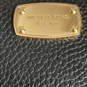 Black pebbled leather zipper wallet. Michael Kors